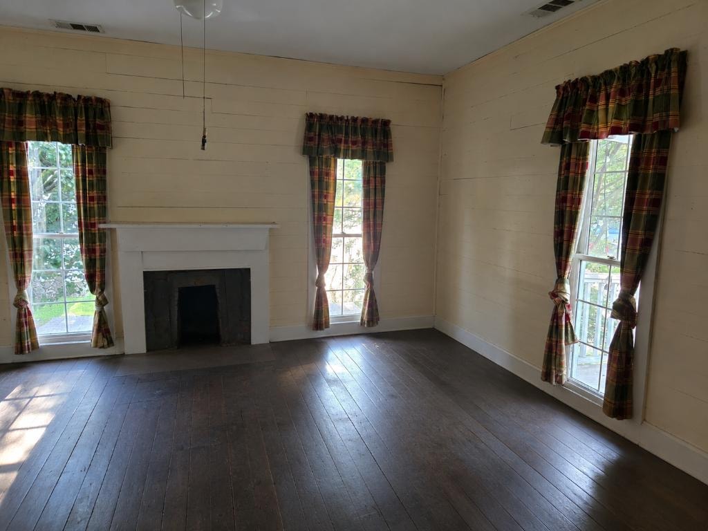Historic room with original fireplace and wide-plank hardwood floors at 19 Talonah